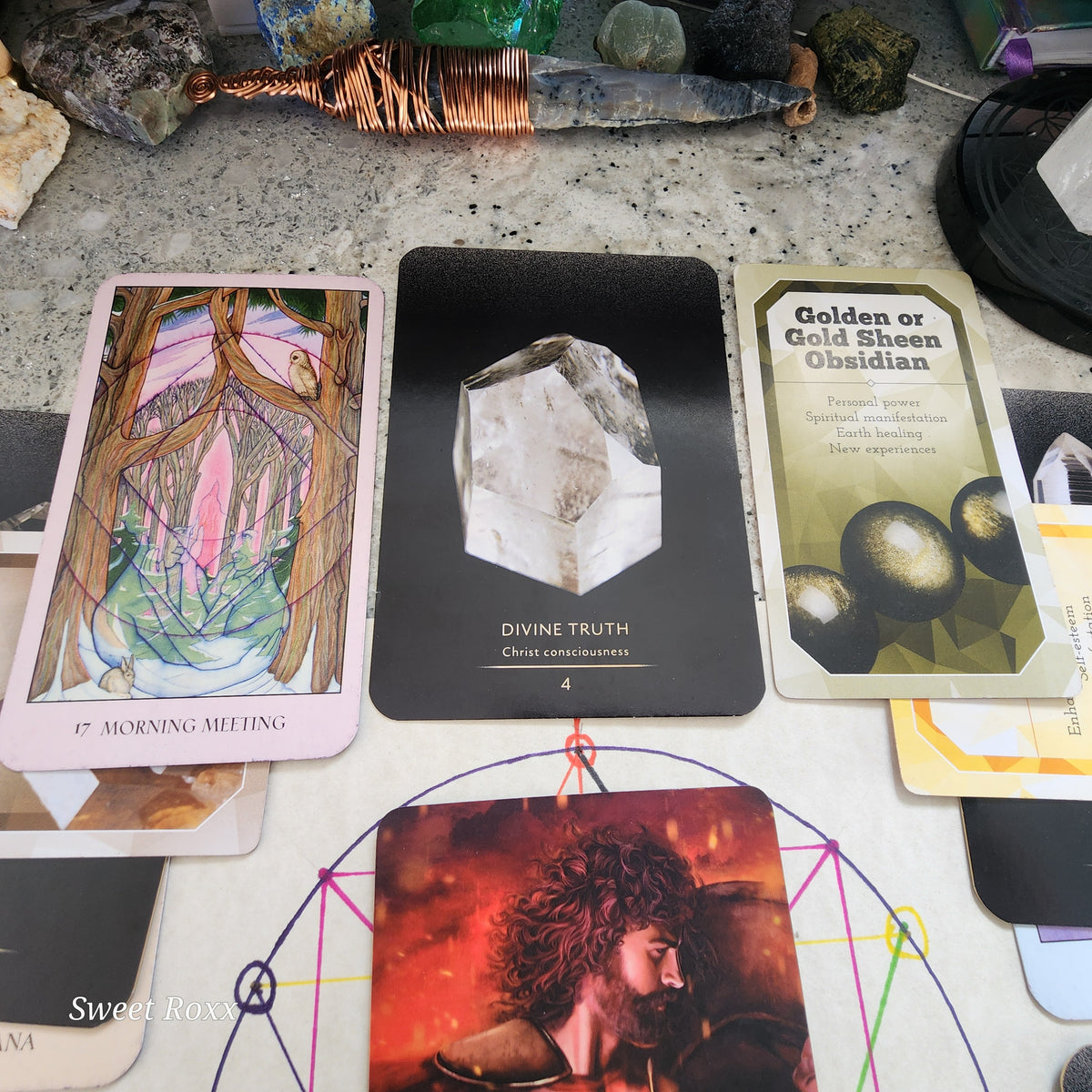 Flower of Life (Top / 12 o'clock): Divine Truth & Intention

Sacred Geometry: Morning Meeting (Communication)

Master Crystal Deva: Divine Truth (Christ Consciousness)

Gaia’s Wisdom: Gold Sheen Obsidian

Core Message: Reaching the crown of the spread, Morning Meeting calls for daily communion with your higher path. Divine Truth clears away self-deception, while Gold Sheen Obsidian anchors the golden light of the divine back down into the subconscious.